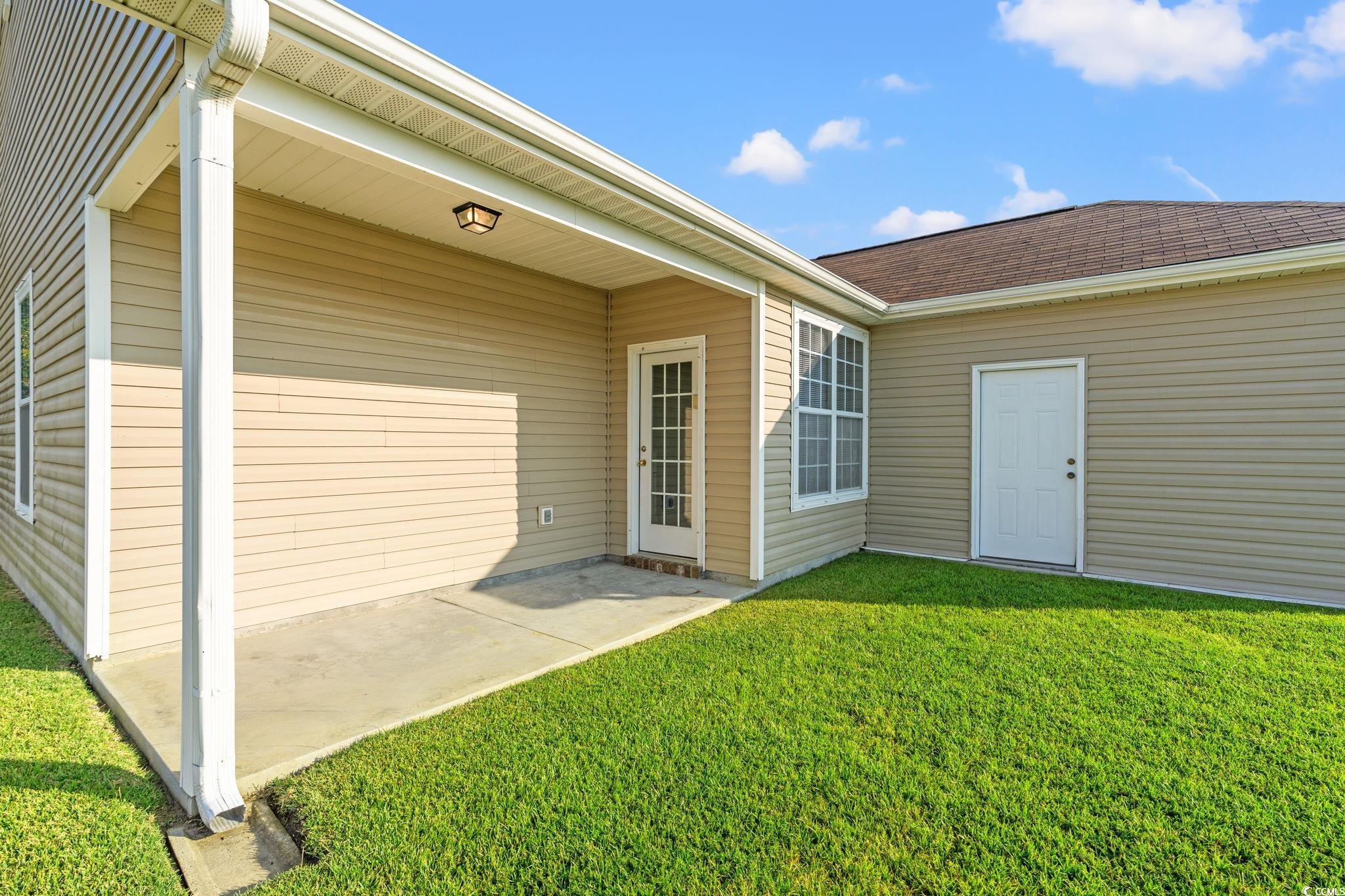 875 Brookline Drive Myrtle Beach, SC 29579 - Photo 27 of 40 Entrance to property featuring a lawn and a patio area