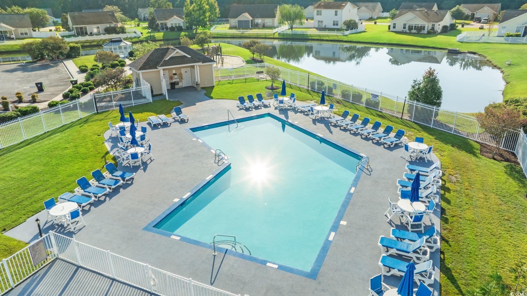 875 Brookline Drive Myrtle Beach, SC 29579 - Photo 39 of 40 Community pool with a water view, a patio, a residential view, and an outbuilding