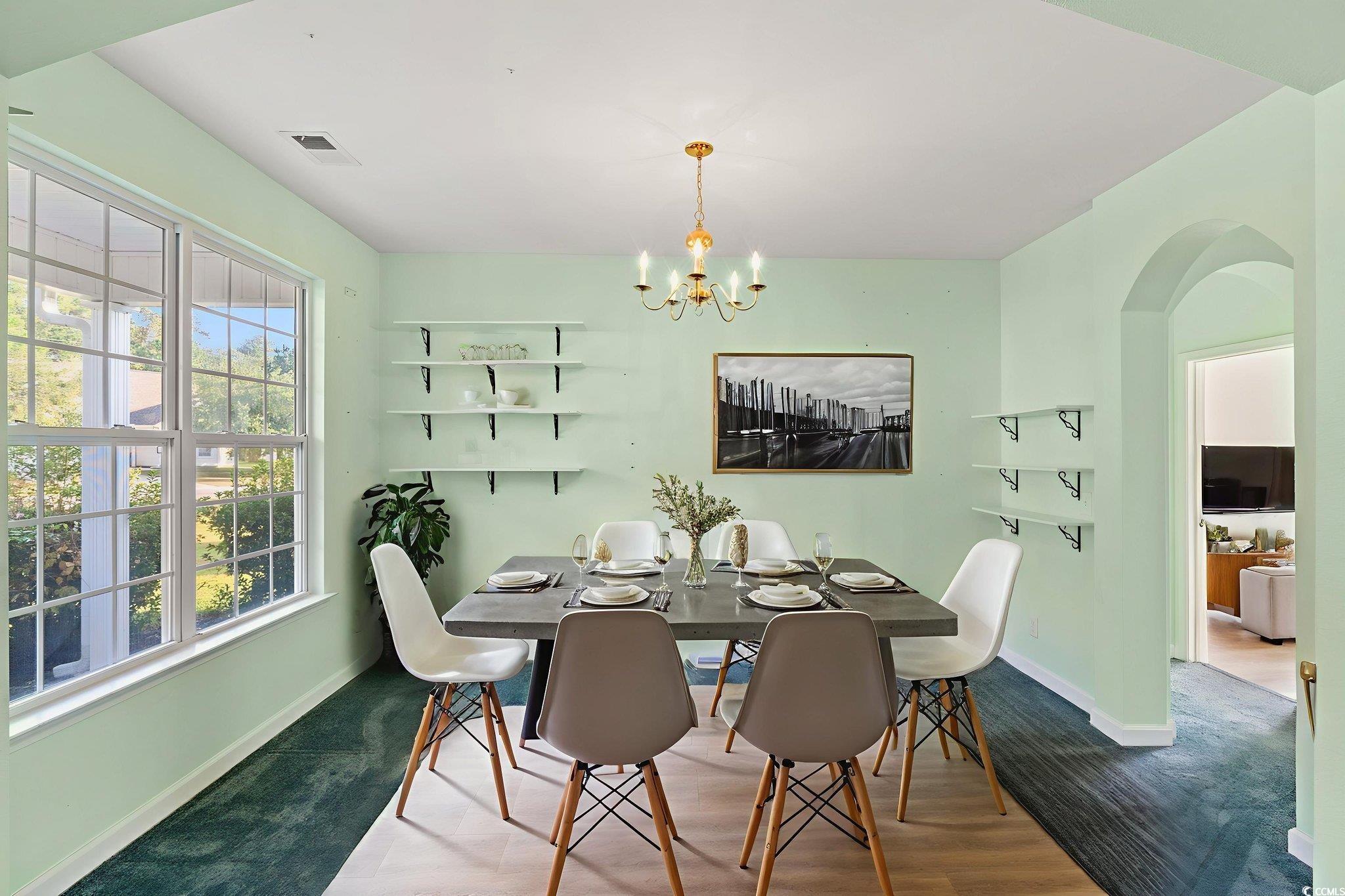 875 Brookline Drive Myrtle Beach, SC 29579 - Photo 4 of 40 Dining area featuring a chandelier, arched walkways, and wood finished floors