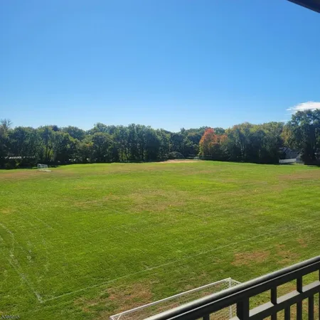 a view of a field with an ocean view
