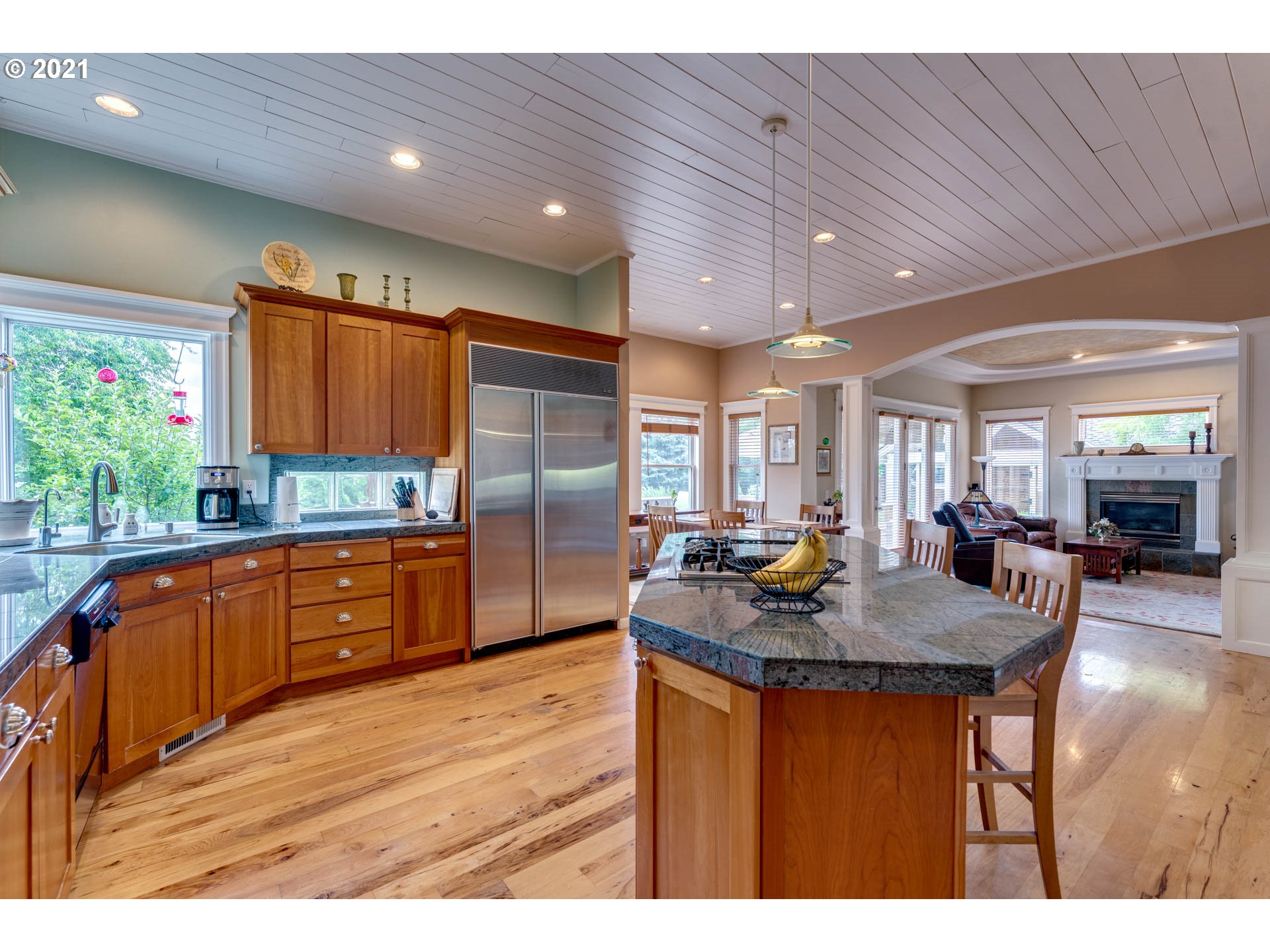 27603 Northeast 10th Avenue Ridgefield, WA 98642 - Photo 13 of 32 a kitchen with stainless steel appliances granite countertop a kitchen island hardwood floor sink stove dining table and chairs
