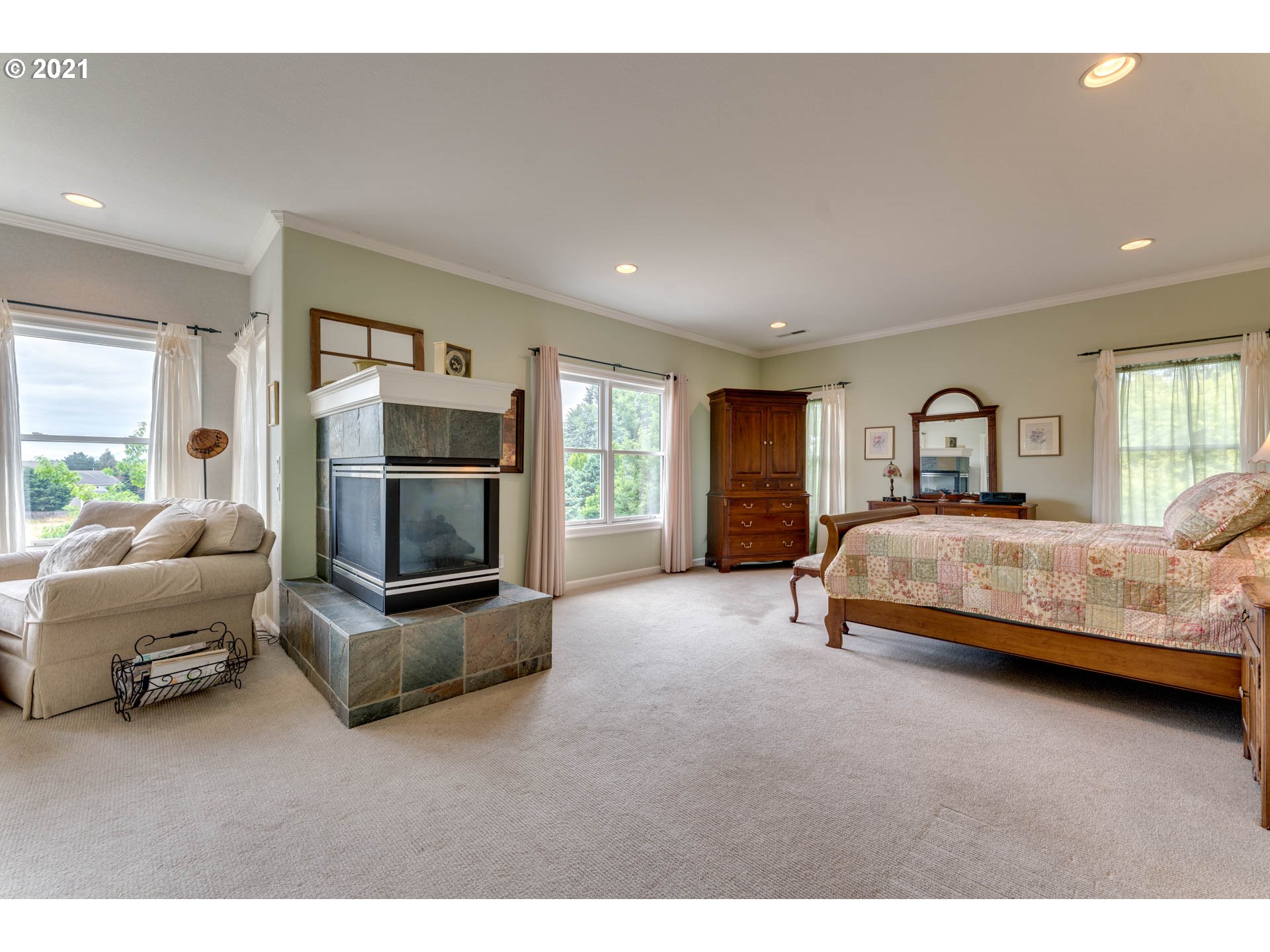 27603 Northeast 10th Avenue Ridgefield, WA 98642 - Photo 25 of 32 a spacious bedroom with a bed a couch and large window