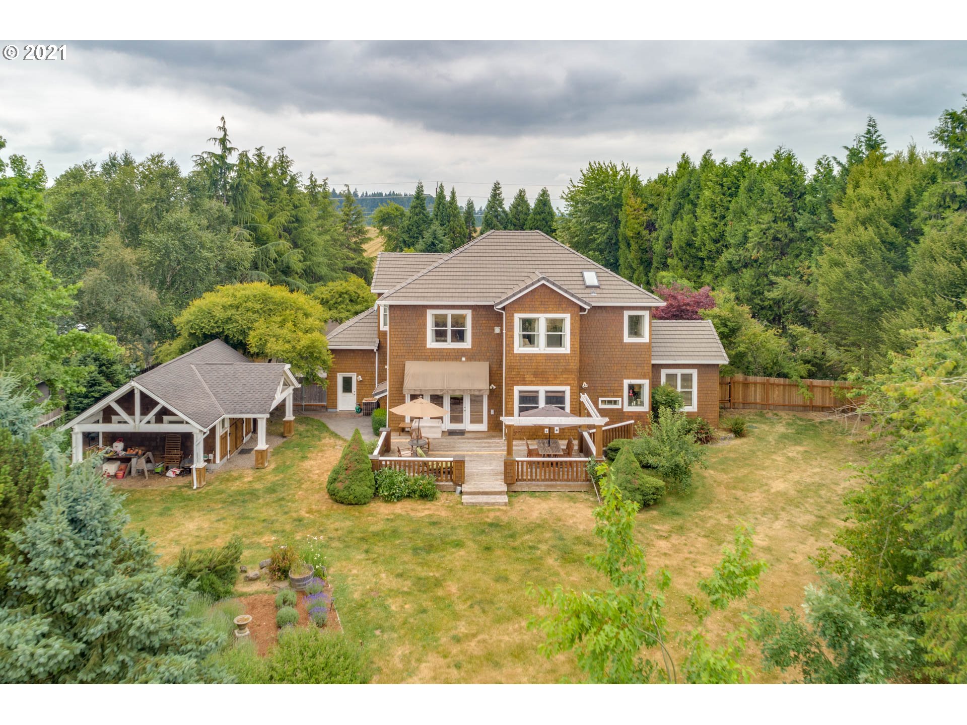 27603 Northeast 10th Avenue Ridgefield, WA 98642 - Photo 30 of 32 a view of a big house with a big yard and large trees