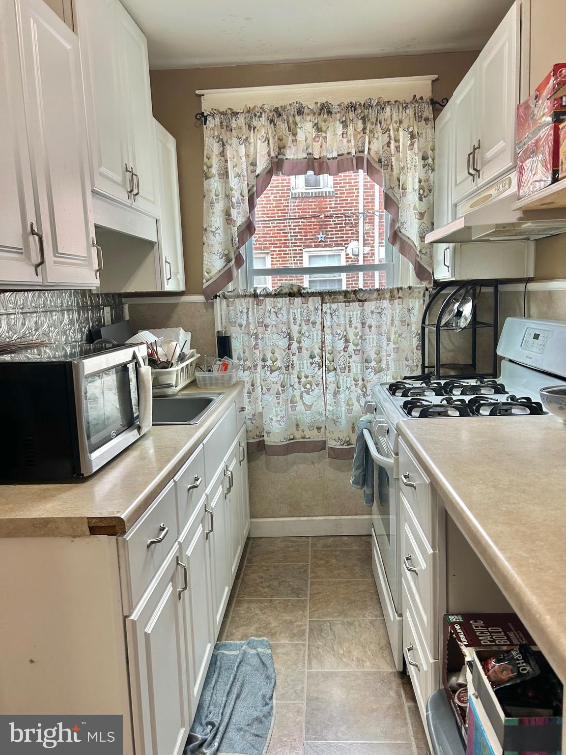 4032 Vista Street Philadelphia, PA 19136 - Photo 6 of 17 a kitchen with a sink stove and cabinets
