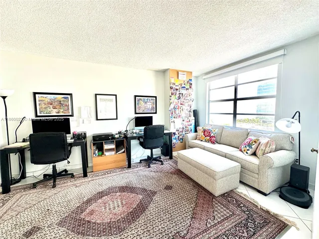a living room with furniture ceiling fan and a rug