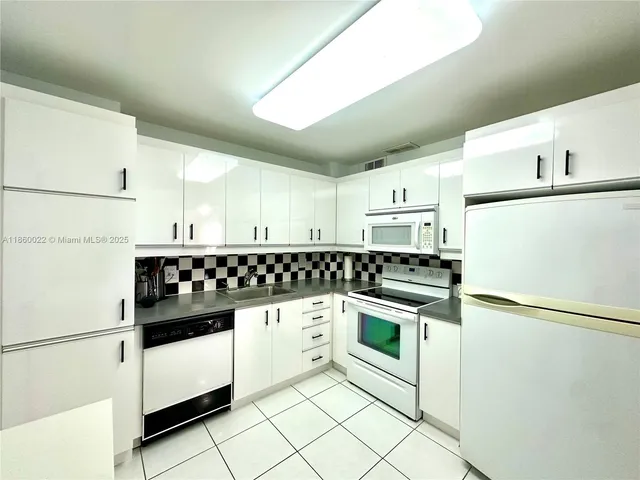 a view of a dining room with furniture and a chandelier