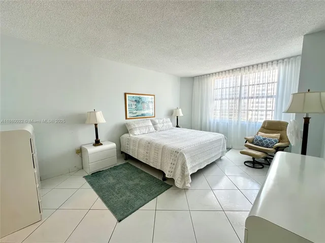 a view of a city from a balcony with chairs