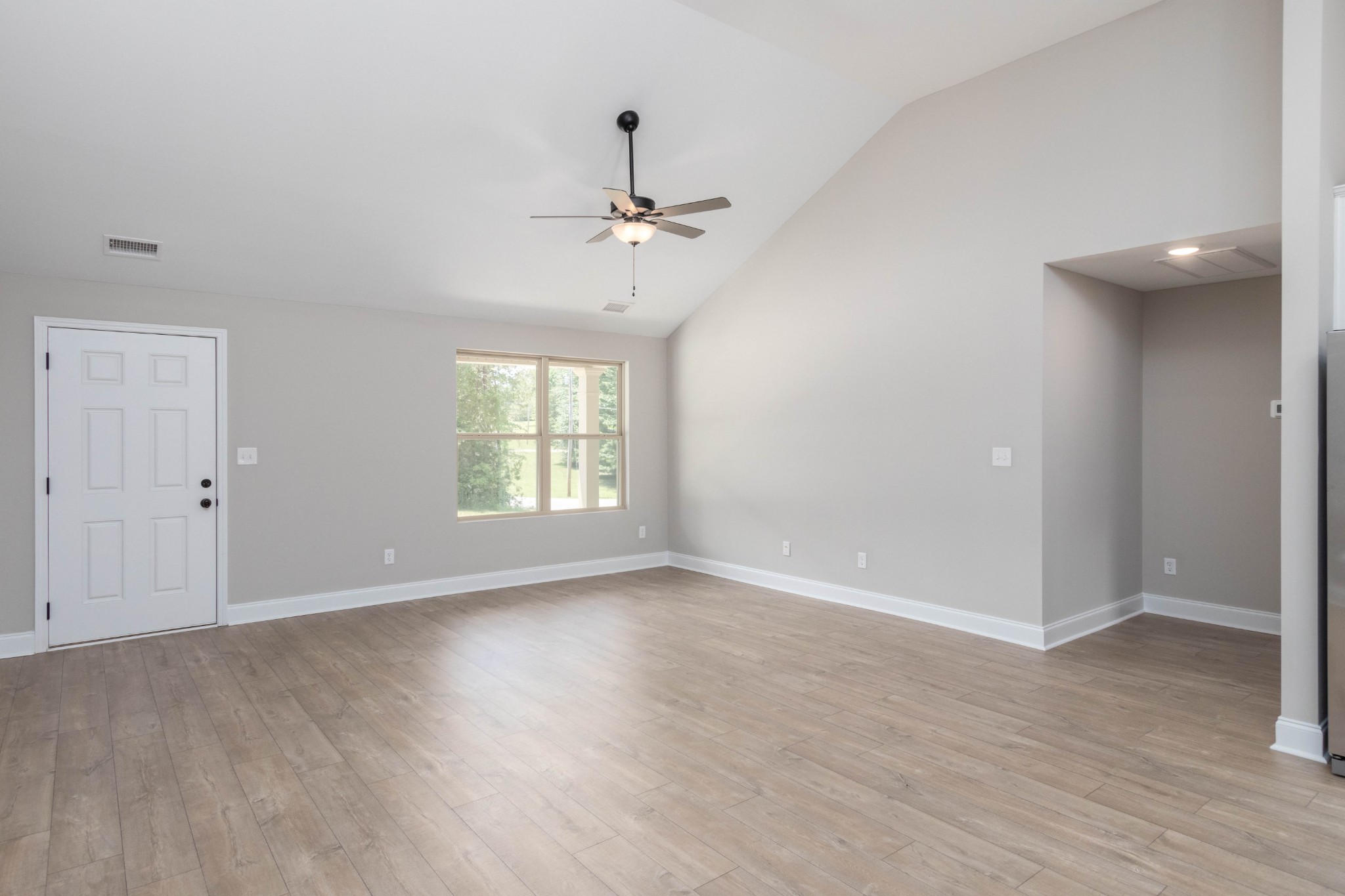 301 Old Columbia Road Dickson, TN 37055 - Photo 11 of 22 an empty room with wooden floor chandelier fan and windows