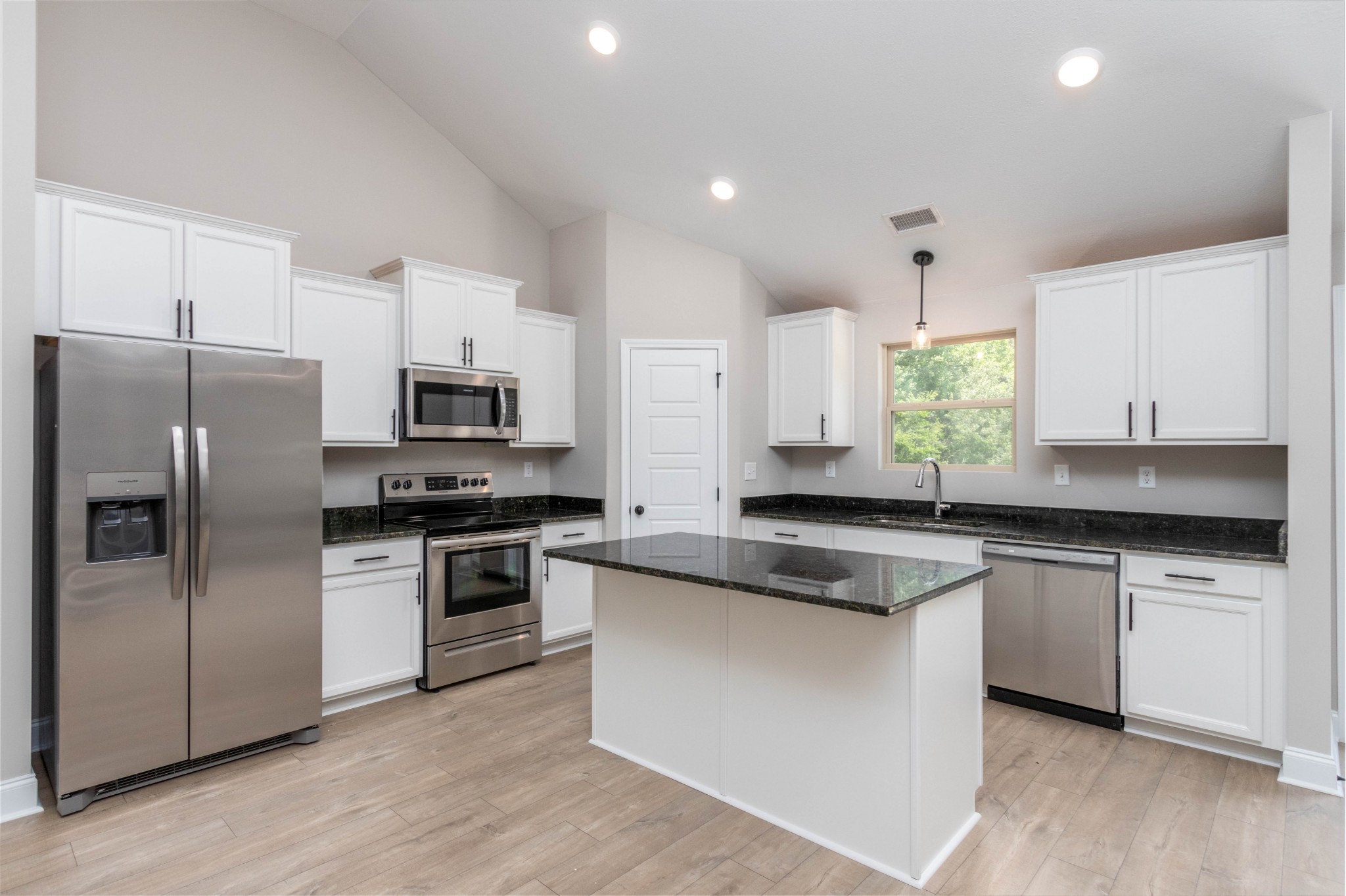 301 Old Columbia Road Dickson, TN 37055 - Photo 7 of 22 a kitchen with stainless steel appliances granite countertop a sink stove microwave and refrigerator