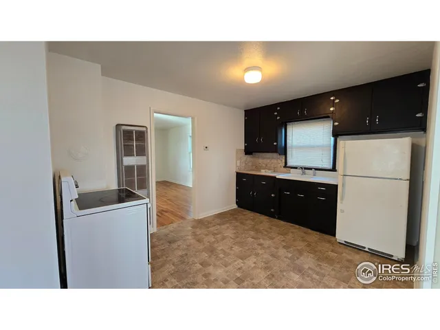 a kitchen with a refrigerator and a stove