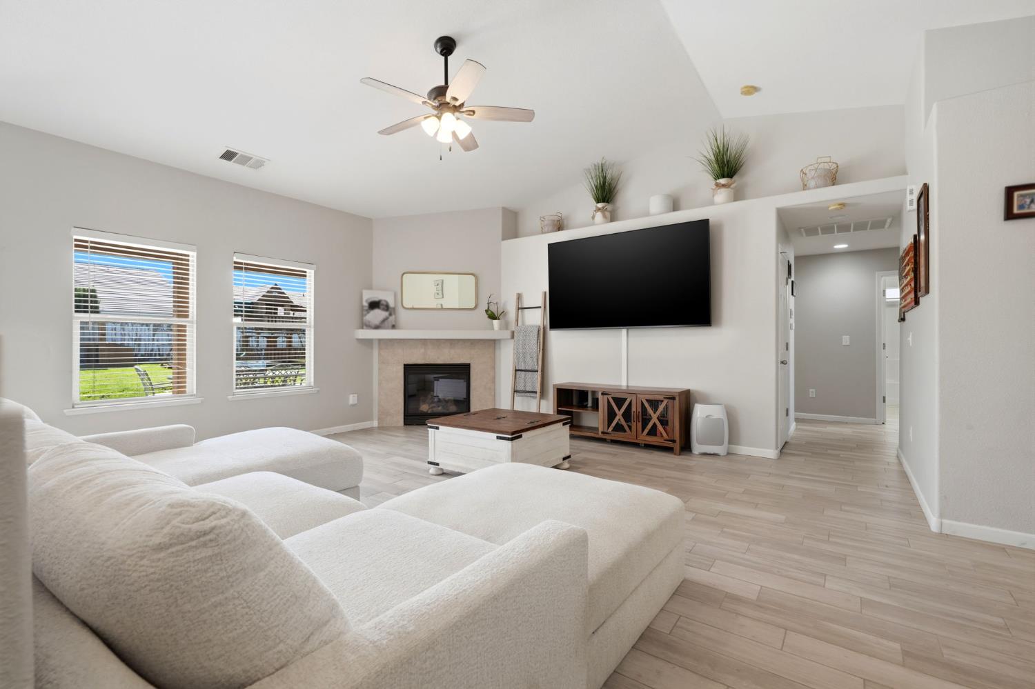 1849 West Spring Crest Street Hanford, CA 93230 - Photo 13 of 45 a living room with furniture a fireplace and a flat screen tv