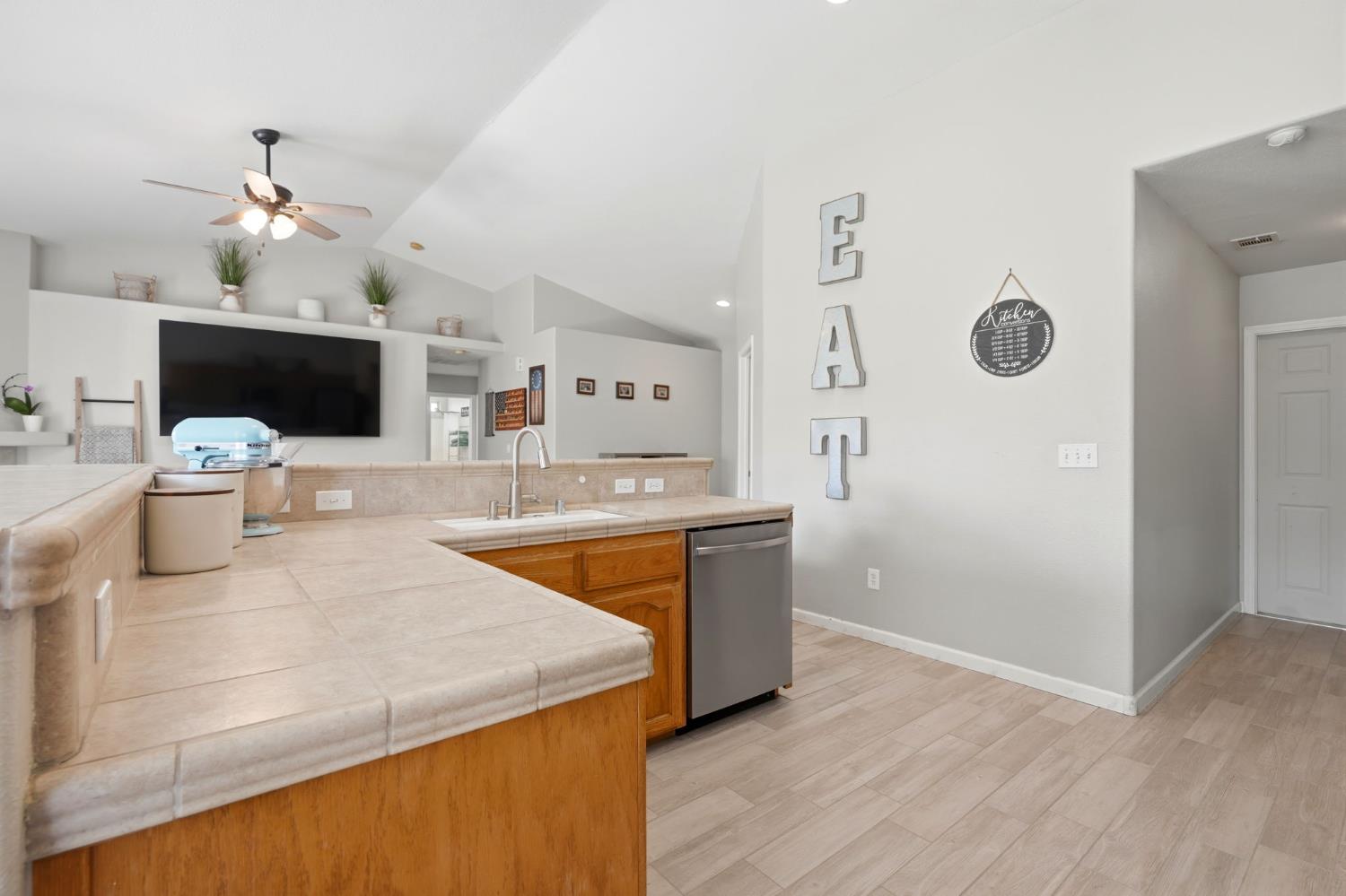 1849 West Spring Crest Street Hanford, CA 93230 - Photo 16 of 45 a large kitchen with stainless steel appliances a stove refrigerator and wooden floor