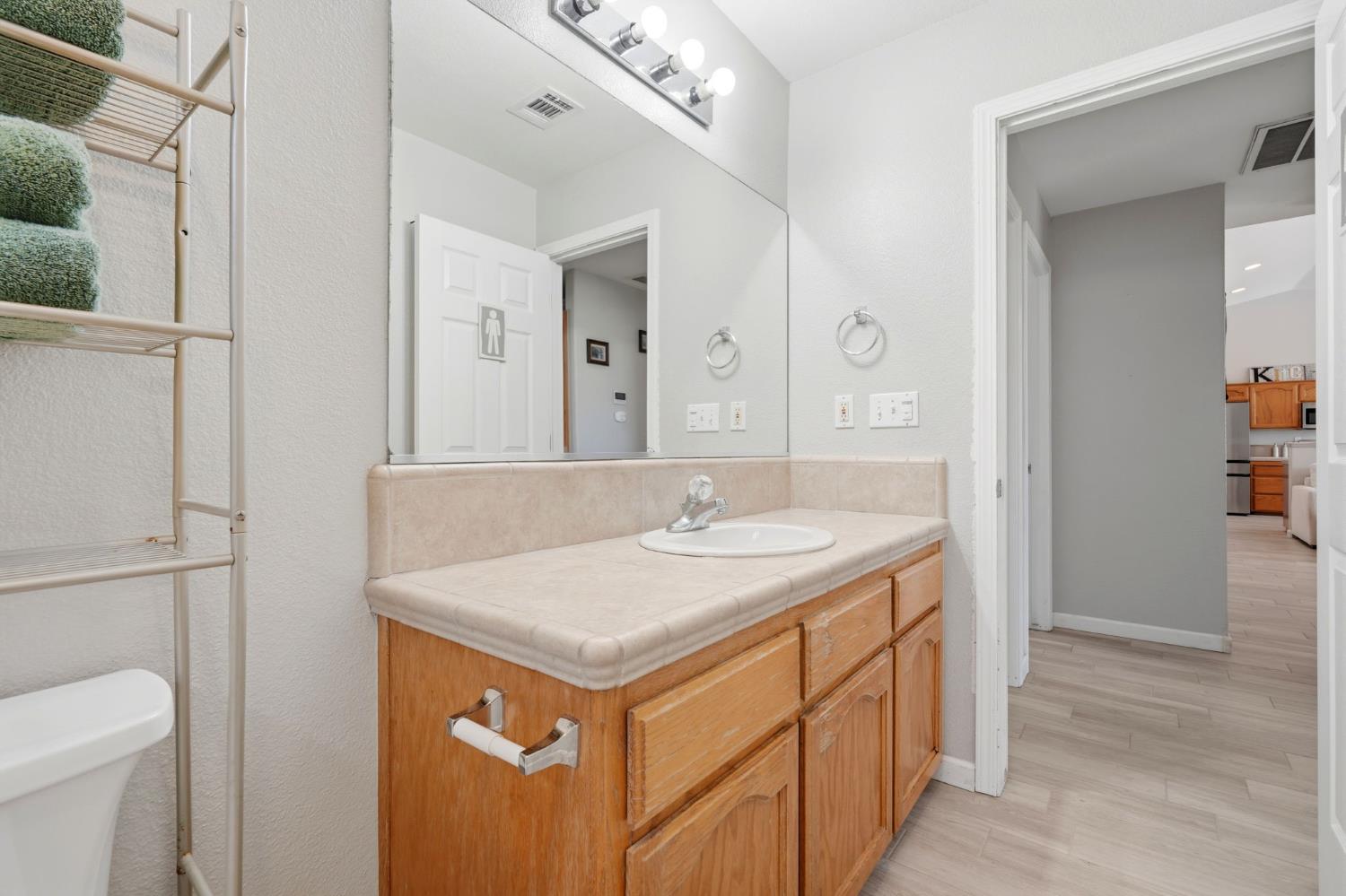 1849 West Spring Crest Street Hanford, CA 93230 - Photo 30 of 45 a bathroom with a sink and a mirror