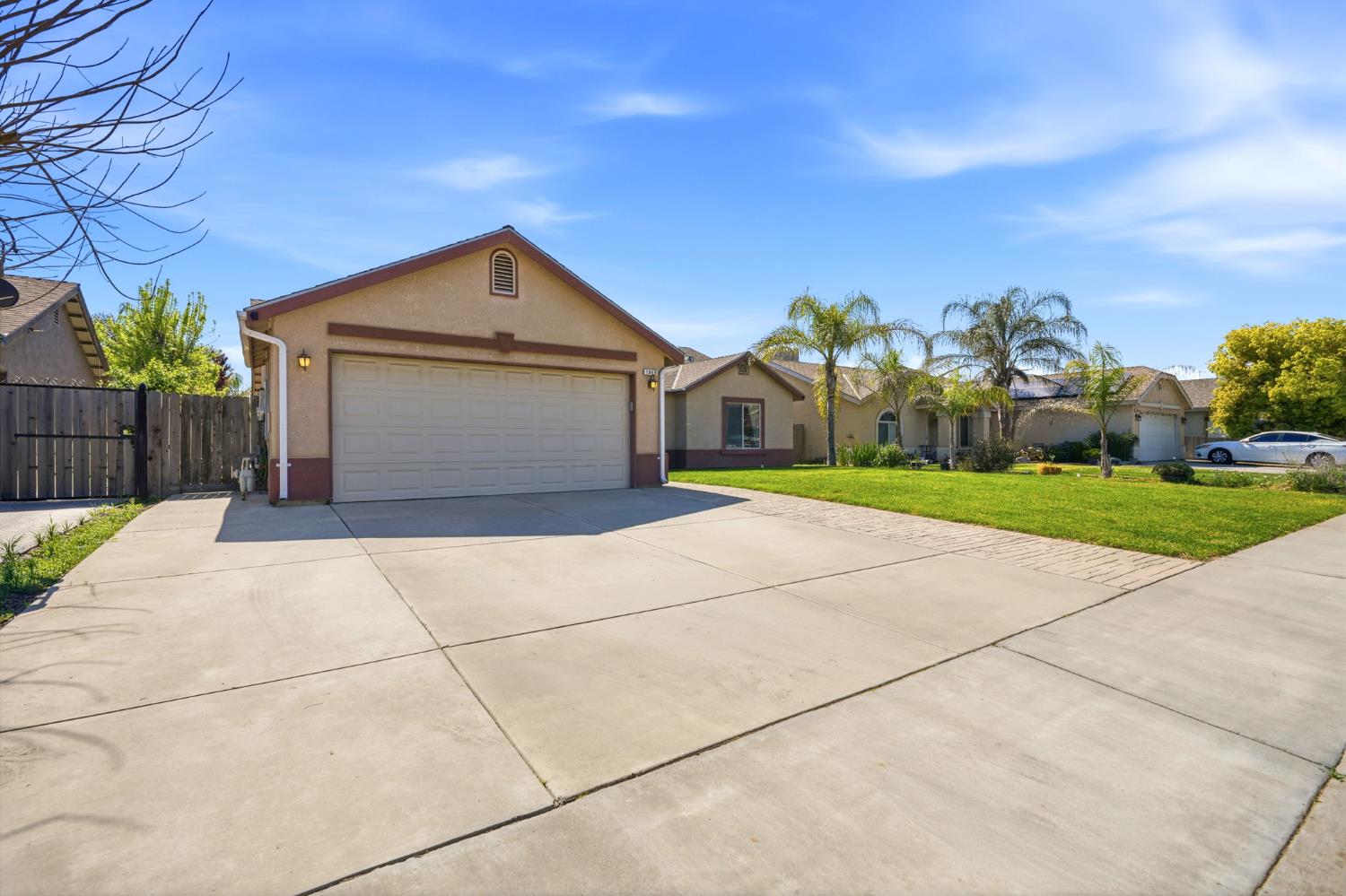 1849 West Spring Crest Street Hanford, CA 93230 - Photo 3 of 45 a front view of a house with a yard and garage