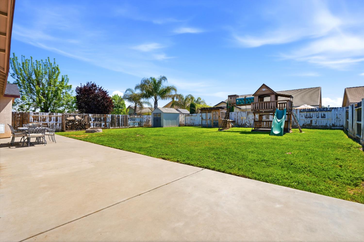 1849 West Spring Crest Street Hanford, CA 93230 - Photo 42 of 45 a view of a house with a big yard and large trees