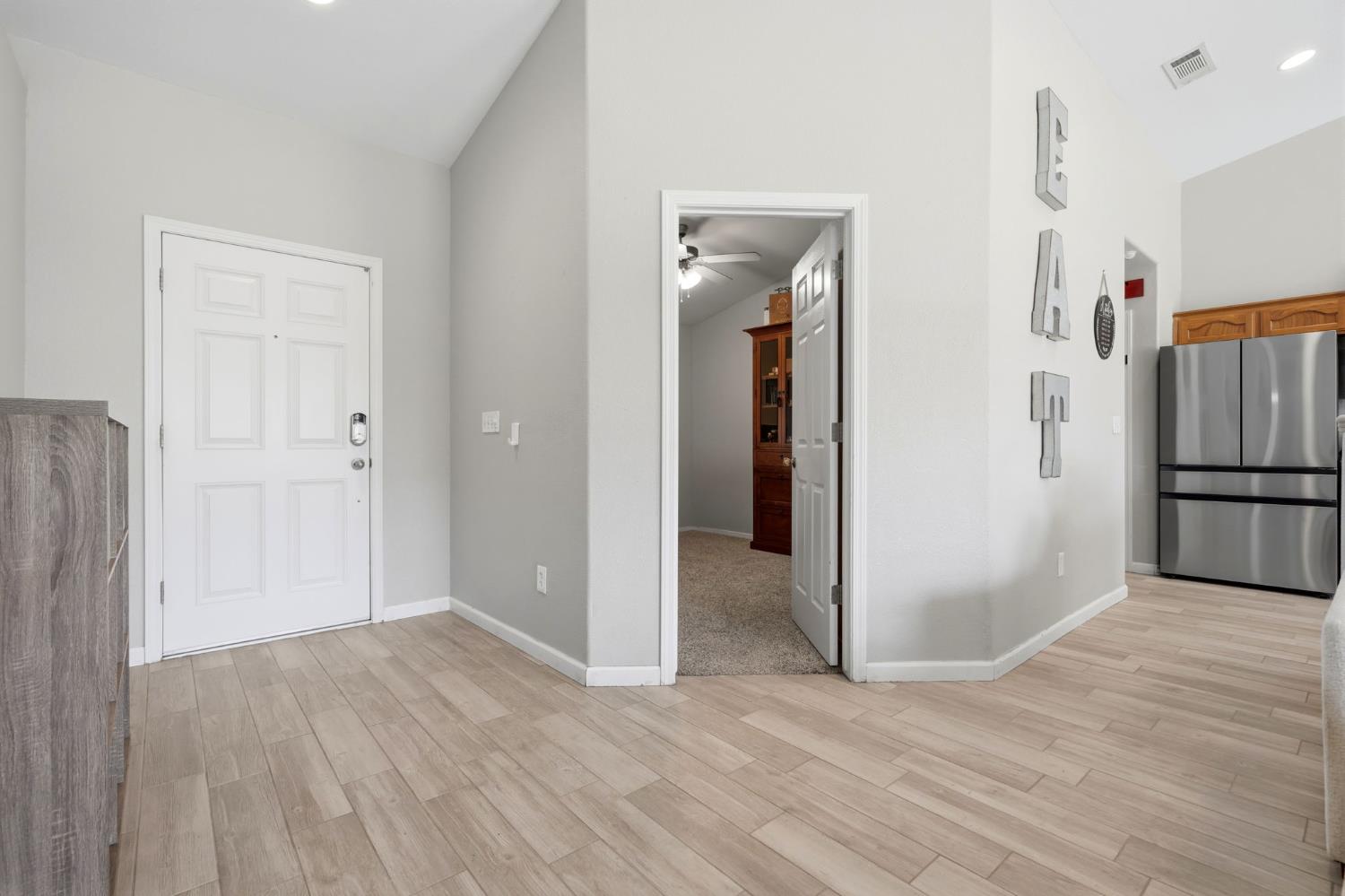 1849 West Spring Crest Street Hanford, CA 93230 - Photo 8 of 45 a view of a hallway with wooden floor and closet area