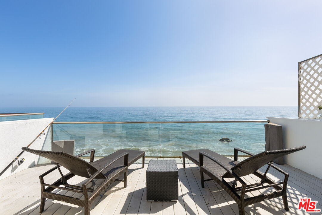 a view of a terrace with two chairs and a table