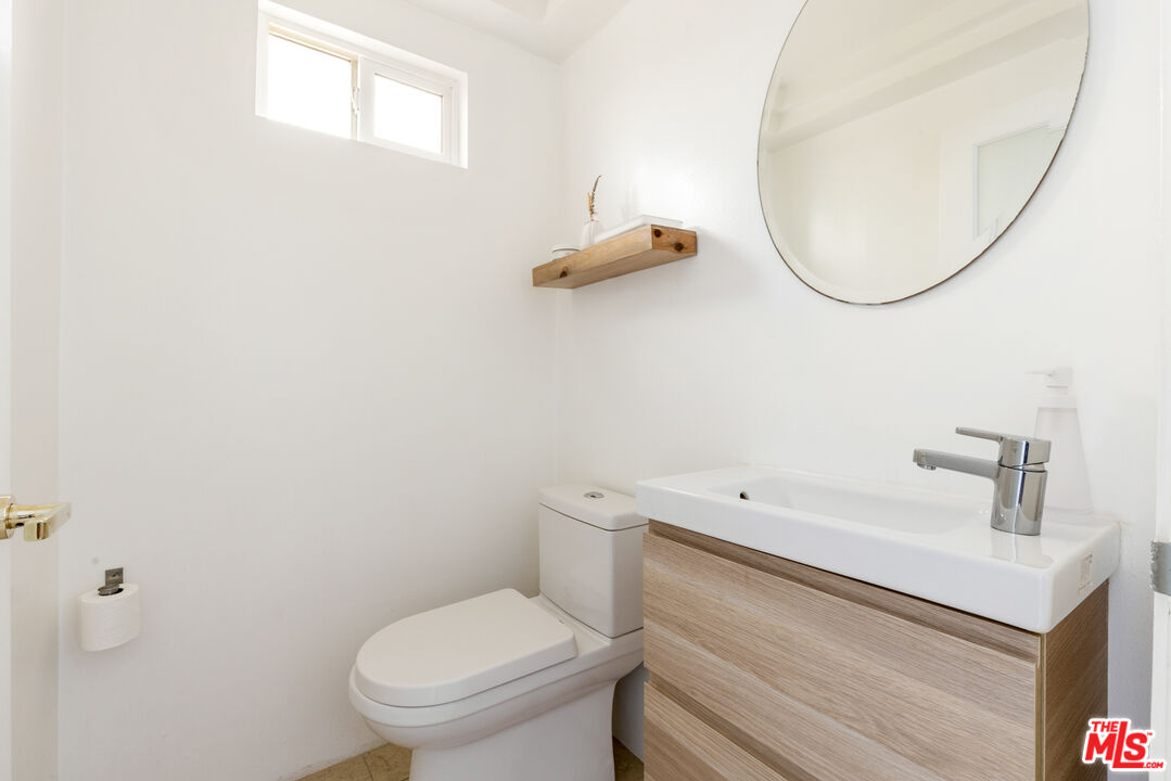 20520 Pacific Coast Highway Malibu, CA 90265 - Photo 14 of 27 a bathroom with a toilet a sink and a mirror