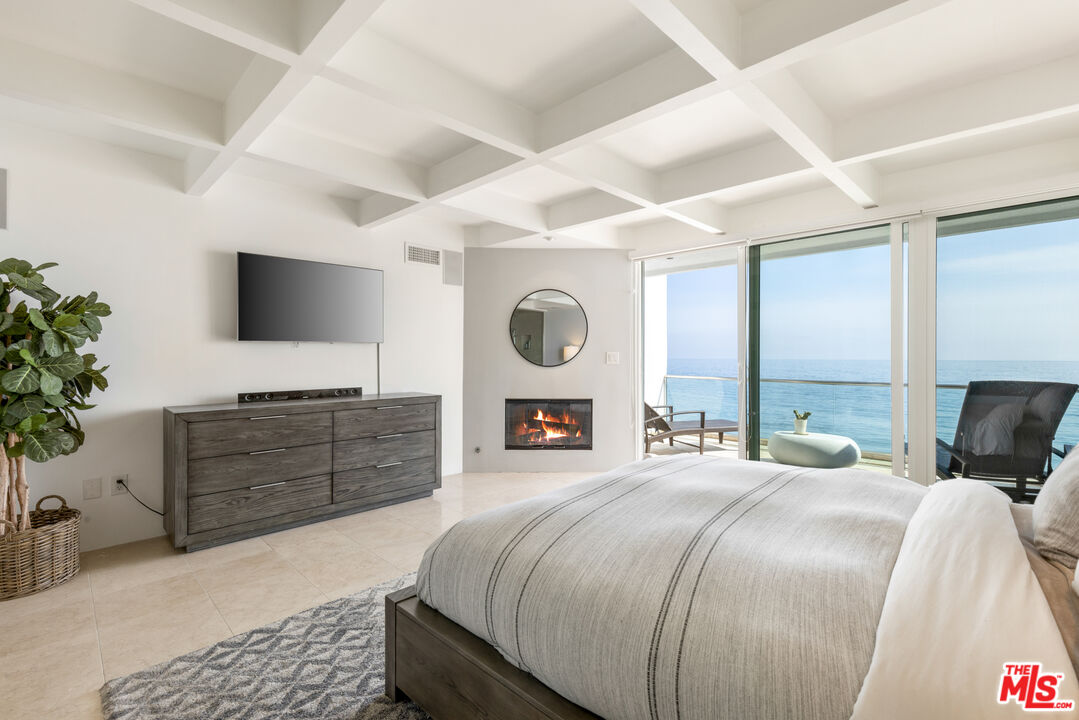 20520 Pacific Coast Highway Malibu, CA 90265 - Photo 17 of 27 a bedroom with a bed and a flat screen tv