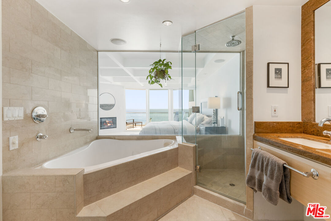 20520 Pacific Coast Highway Malibu, CA 90265 - Photo 19 of 27 a spacious bathroom with a granite countertop sink a mirror and shower