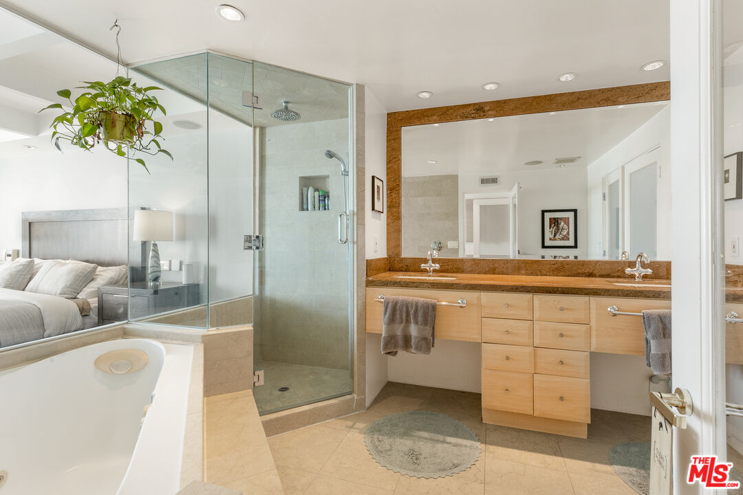 20520 Pacific Coast Highway Malibu, CA 90265 - Photo 20 of 27 a spacious bathroom with a double vanity sink mirror and shower