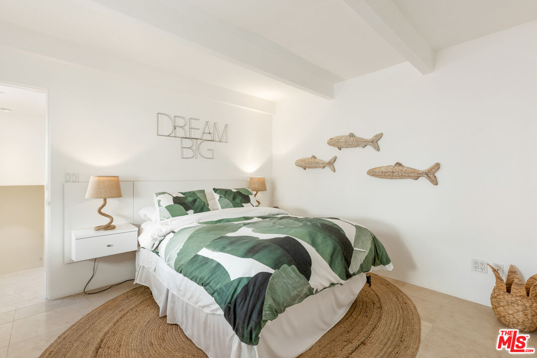 20520 Pacific Coast Highway Malibu, CA 90265 - Photo 21 of 27 a bedroom with a bed and painting on the wall