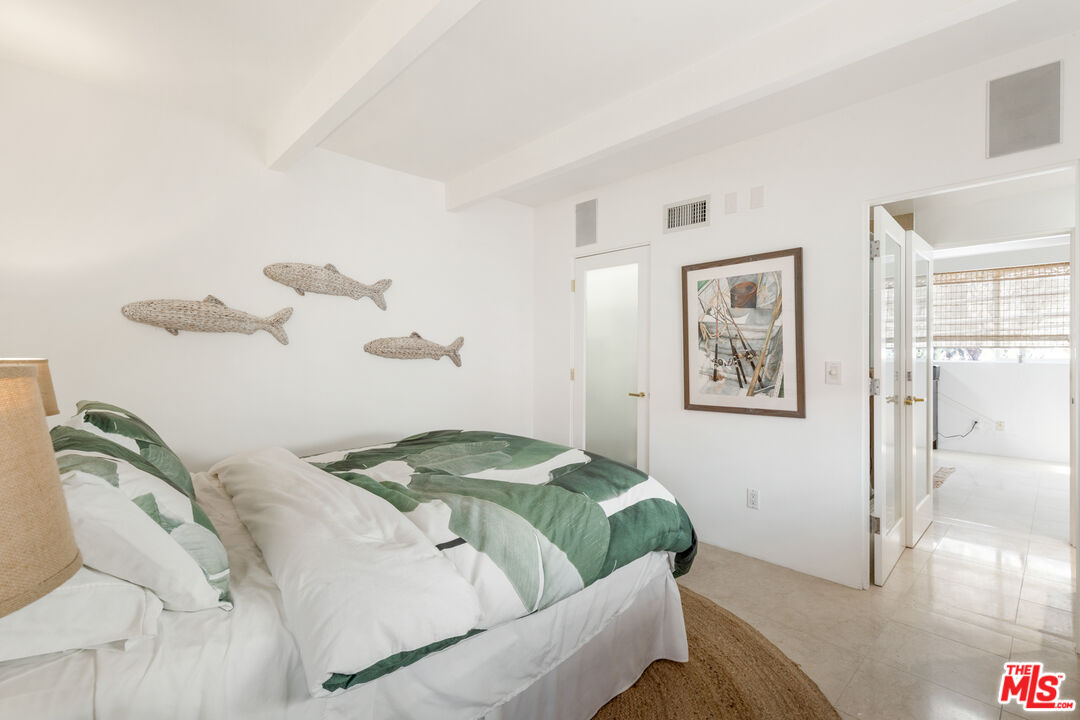 20520 Pacific Coast Highway Malibu, CA 90265 - Photo 22 of 27 a bedroom with a bed and a painting on the wall