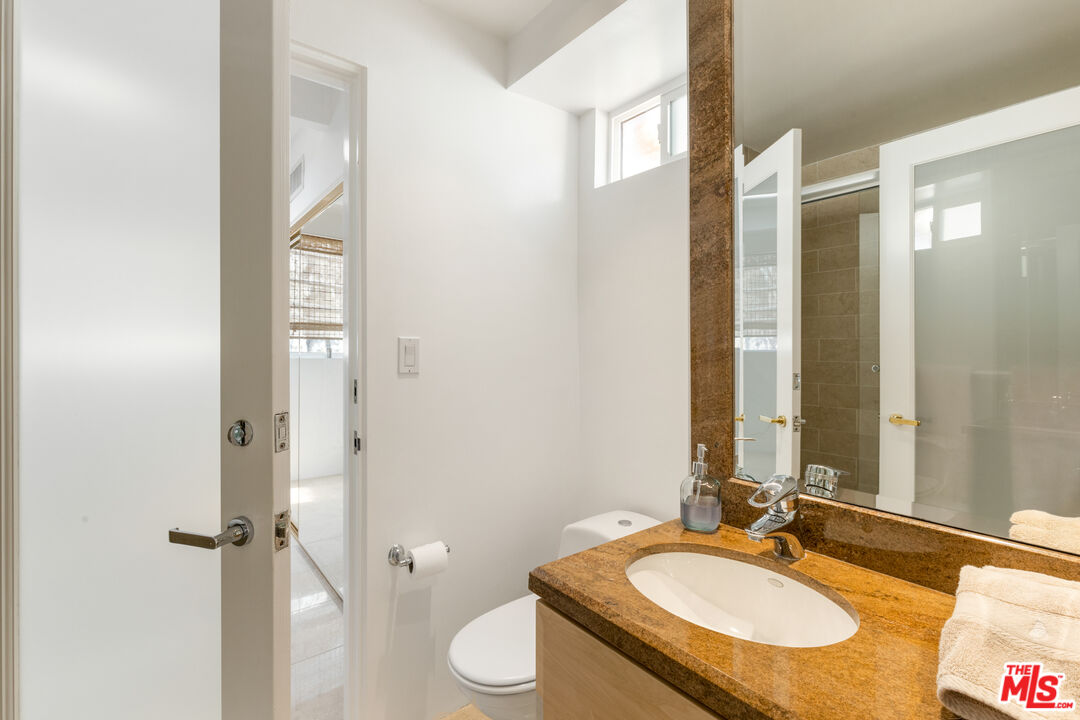 20520 Pacific Coast Highway Malibu, CA 90265 - Photo 23 of 27 a bathroom with a granite countertop sink and a mirror