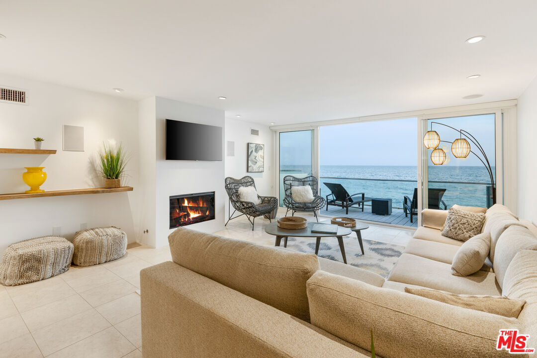 20520 Pacific Coast Highway Malibu, CA 90265 - Photo 5 of 27 a living room with furniture a fireplace and a flat screen tv