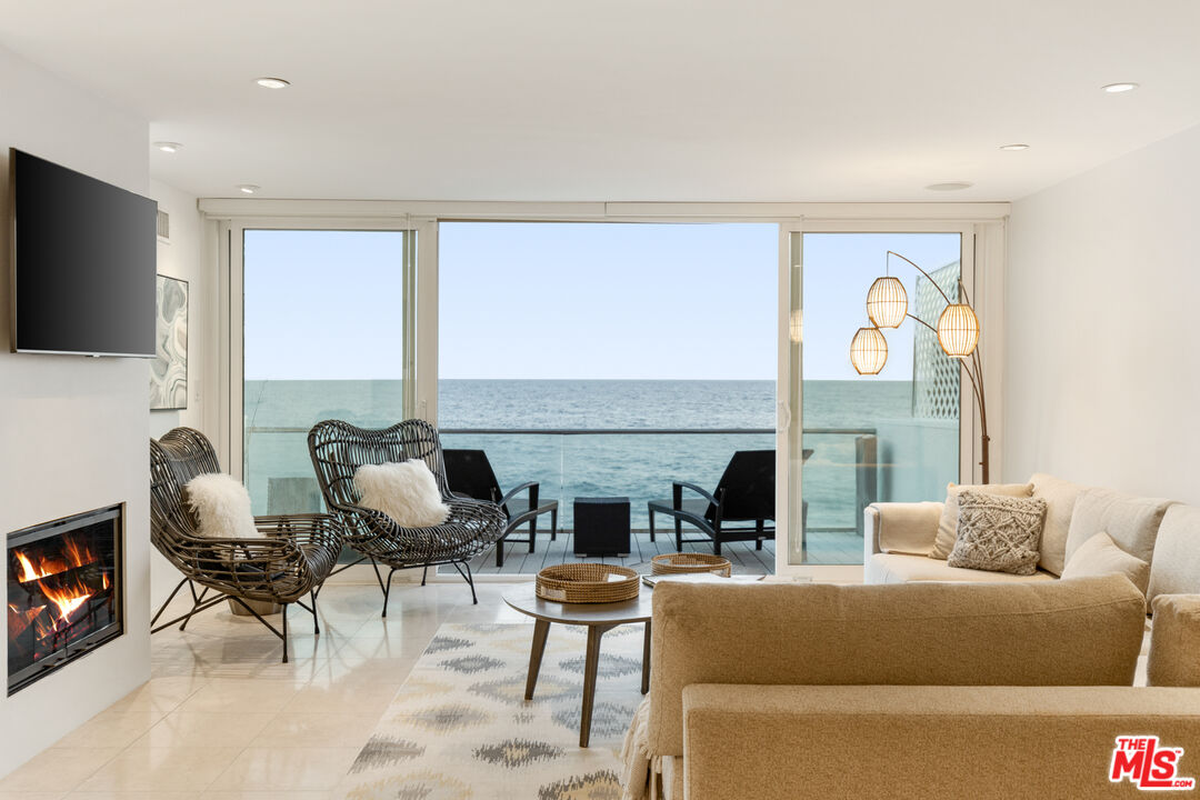 20520 Pacific Coast Highway Malibu, CA 90265 - Photo 6 of 27 a living room with fireplace furniture and a flat screen tv