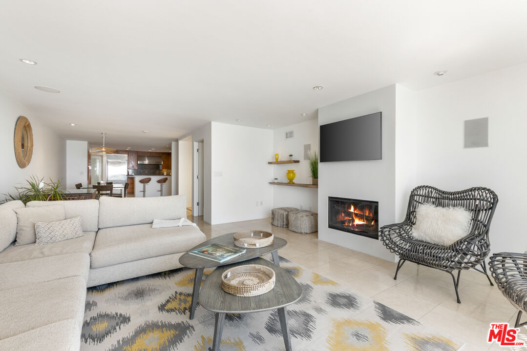 20520 Pacific Coast Highway Malibu, CA 90265 - Photo 7 of 27 a living room with furniture a fireplace and a flat screen tv