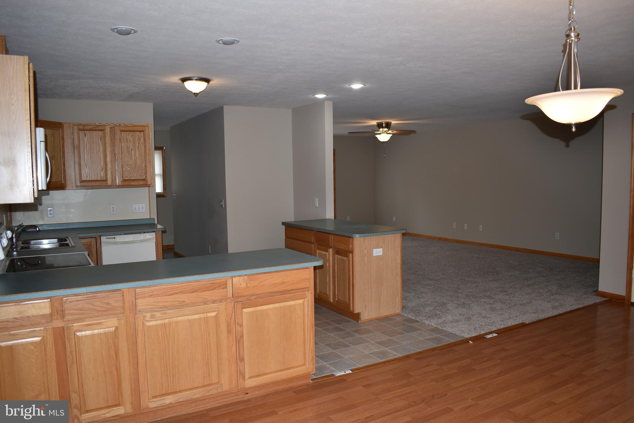13704 Orchard Ridge Road Hancock, MD 21750 - Photo 4 of 27 Laminate flooring in dining room, open to kitchen