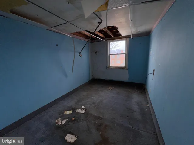 a view of a hallway with filled with furniture