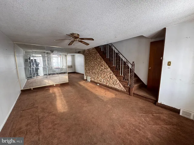 a view of an empty room with stairs