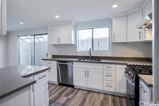 1050 Spazier Avenue, Unit 5 Glendale, CA 91201 - Photo 11 of 27 a kitchen with stainless steel appliances granite countertop a sink stove and white cabinets