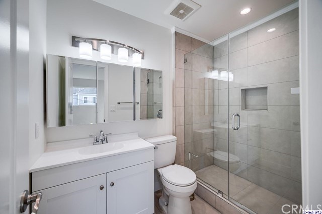 1050 Spazier Avenue, Unit 5 Glendale, CA 91201 - Photo 16 of 27 a bathroom with a sink toilet a mirror and shower