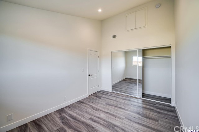 1050 Spazier Avenue, Unit 5 Glendale, CA 91201 - Photo 18 of 27 a view of an empty room and wooden floor