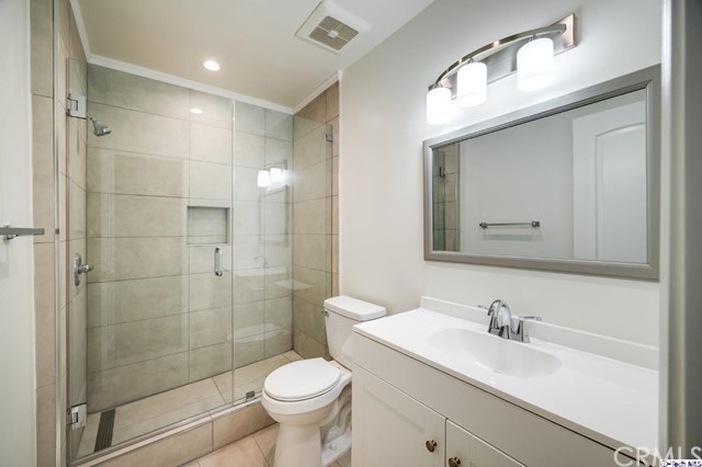 1050 Spazier Avenue, Unit 5 Glendale, CA 91201 - Photo 19 of 27 a bathroom with a sink toilet a mirror and shower