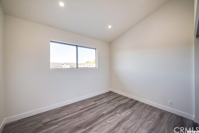 1050 Spazier Avenue, Unit 5 Glendale, CA 91201 - Photo 20 of 27 an empty room with wooden floor and windows