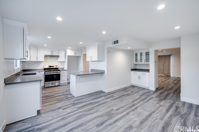 1050 Spazier Avenue, Unit 5 Glendale, CA 91201 - Photo 7 of 27 a kitchen with a refrigerator and a stove top oven