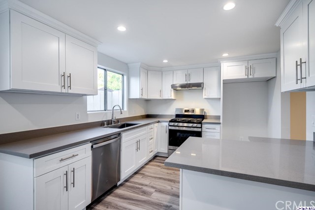 1050 Spazier Avenue, Unit 5 Glendale, CA 91201 - Photo 9 of 27 a kitchen with granite countertop a sink a stove and cabinets