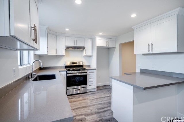 1050 Spazier Avenue, Unit 5 Glendale, CA 91201 - Photo 10 of 27 a kitchen with granite countertop a stove and a sink