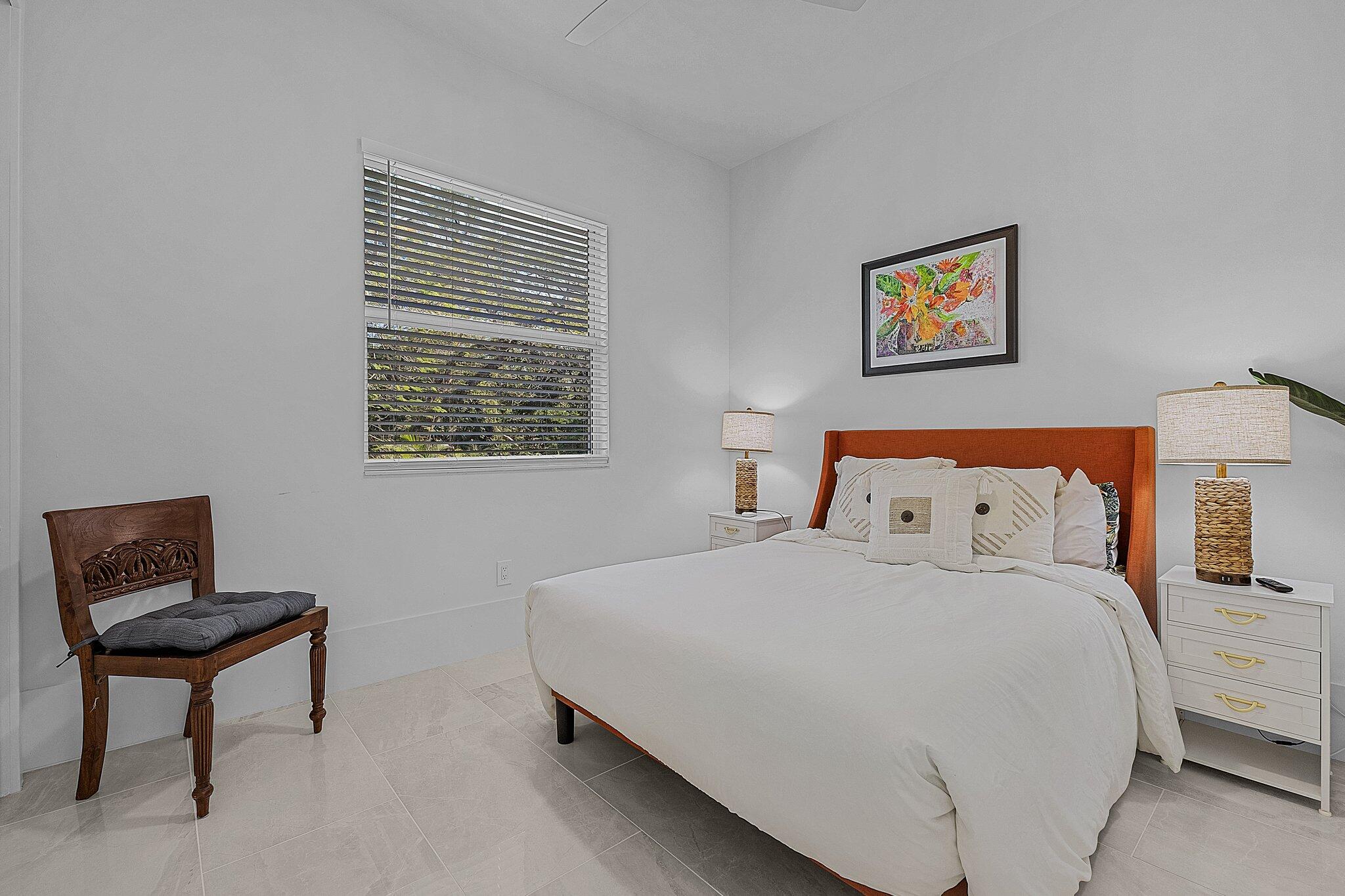 2499 Pine Street Naples, FL 34112 - Photo 12 of 18 a bedroom with a bed and a chair