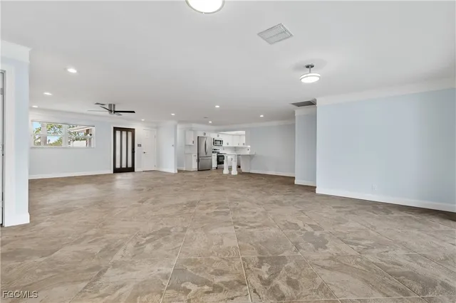 a view of a livingroom with furniture and a window