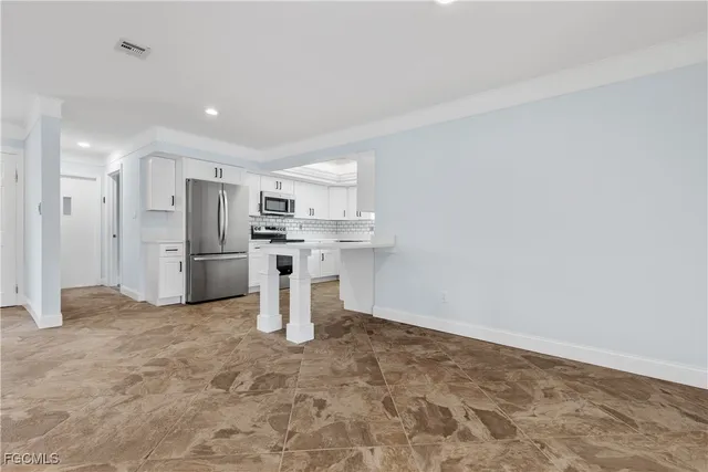 a kitchen with stainless steel appliances a refrigerator and a sink
