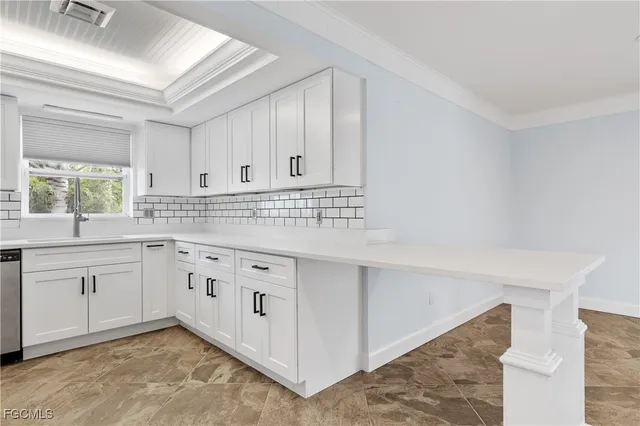 a kitchen with granite countertop white cabinets and white appliances