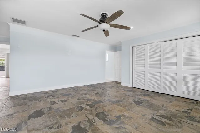 an empty room with ceiling fan