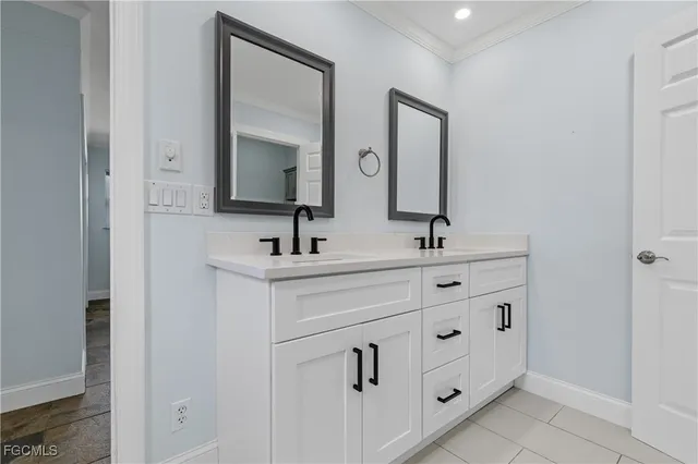 a bathroom with double vanity sink and mirror