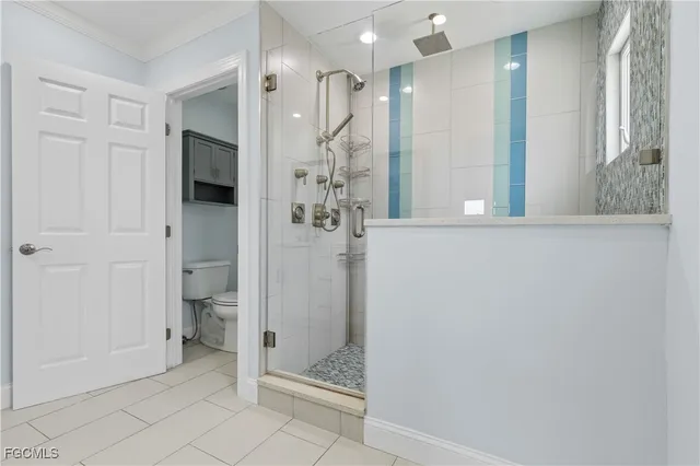 a bathroom with a glass shower door and a sink