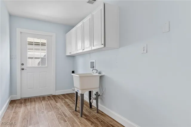 a view of a room with wooden floor and a sink